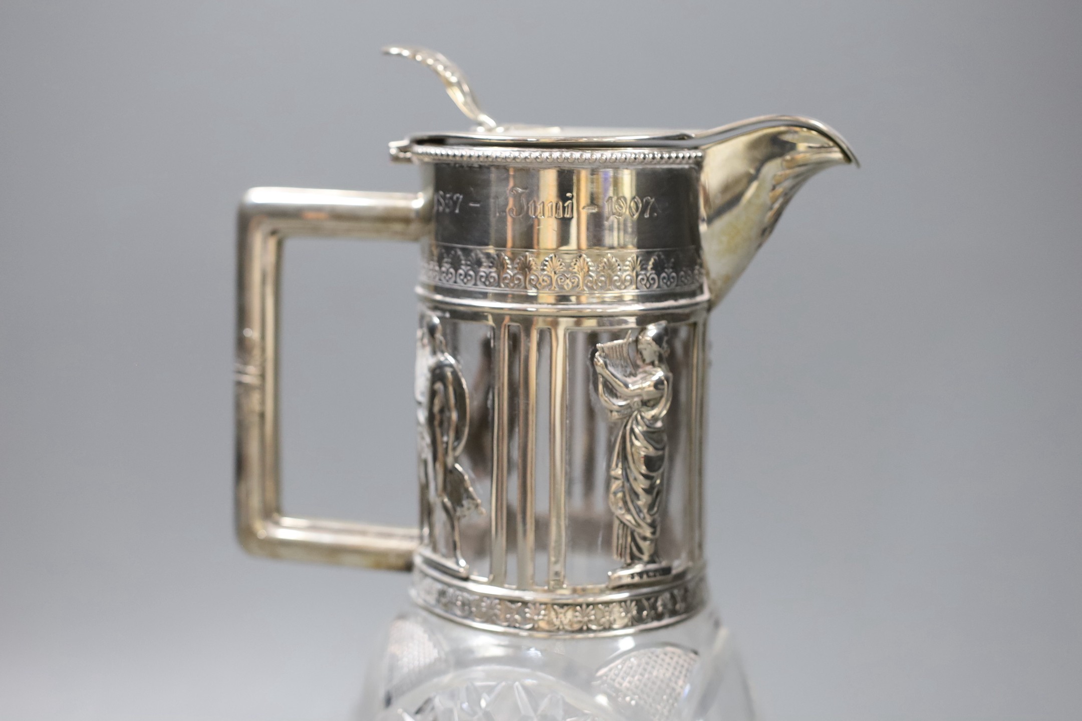 A late 19th/early 20th century German 800 standard white metal mounted cult glass claret jug, retailed by Friedlaender, height 26.2cm.